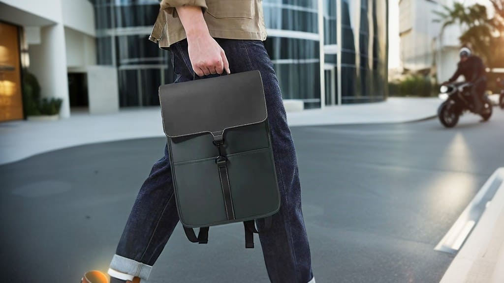 A model presents a product image of a professional waterproof backpack with a 16-inch laptop for business commuting4