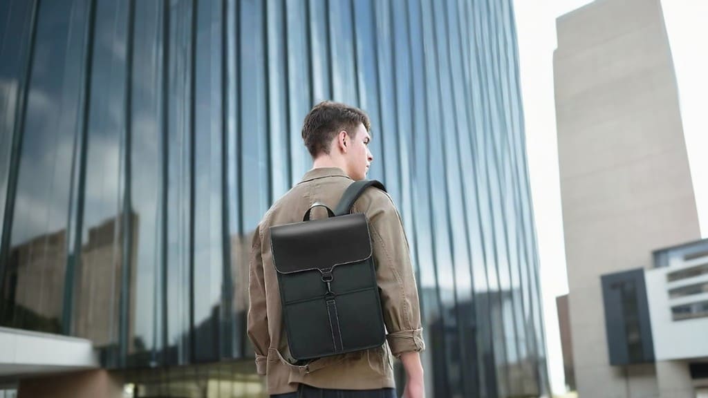 A model presents a product image of a professional waterproof backpack with a 16-inch laptop for business commuting2
